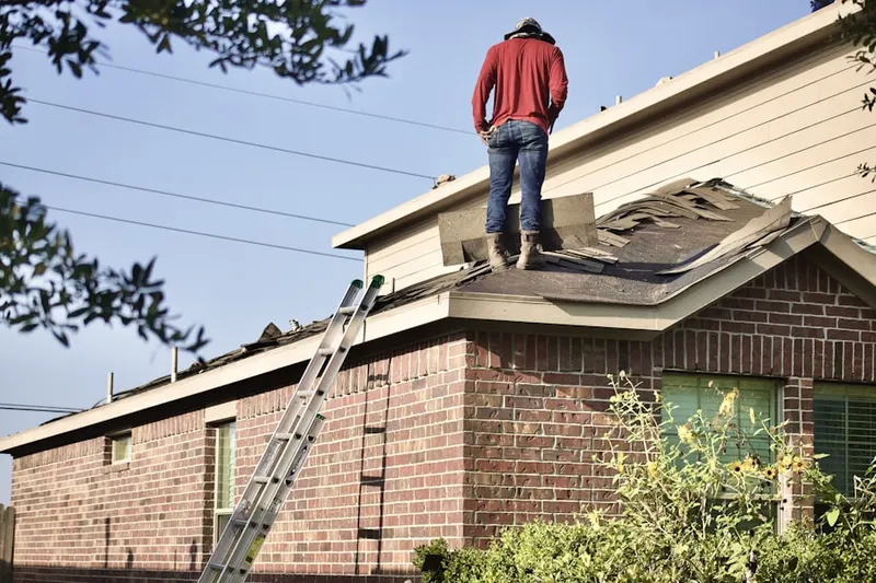Professional roofer working on a residential roof in Copeville